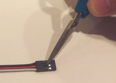 Lift the tabs on one end of the 3 pin cable.