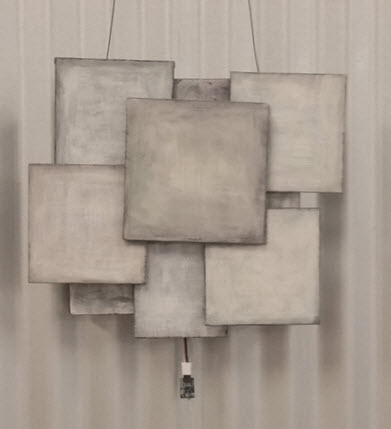 6 overlapping canvas panels painted slightly different shades of gray, all squared up.
