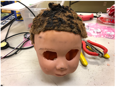 Spooky Doll head with eyes removed for Neo Pixel attachment.