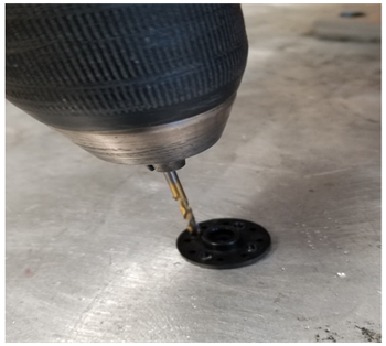 Drilling holes in the laser cut servo wheel.
