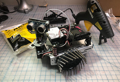 Workbench with the cyber:bot and its modified traction-wheels.